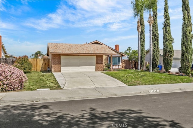 10069 Hershey Way, Riverside, CA 92503 - view of front facade with brick siding, an attached garage, concrete driveway, and a chimney
