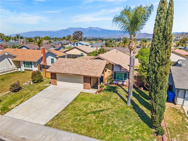 10069 Hershey Way, Riverside, CA 92503 - view of front of house with brick siding, a residential view, an attached garage, and driveway