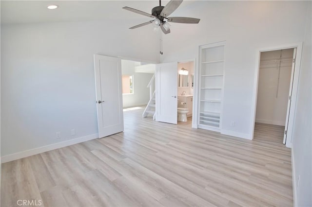 17114 Bluewater Ln Unit 141, Huntington Beach, CA 92649 - unfurnished bedroom with baseboards, a high ceiling, a walk in closet, light wood-style floors, and recessed lighting