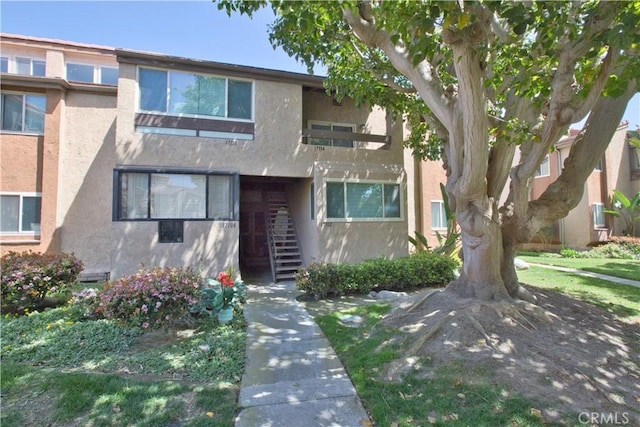 17114 Bluewater Ln Unit 141, Huntington Beach, CA 92649 - view of property featuring stucco siding and stairway