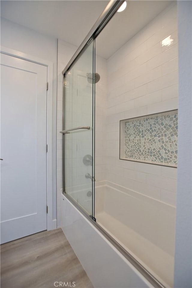 17114 Bluewater Ln Unit 141, Huntington Beach, CA 92649 - full bathroom featuring combined bath / shower with glass door and wood finished floors