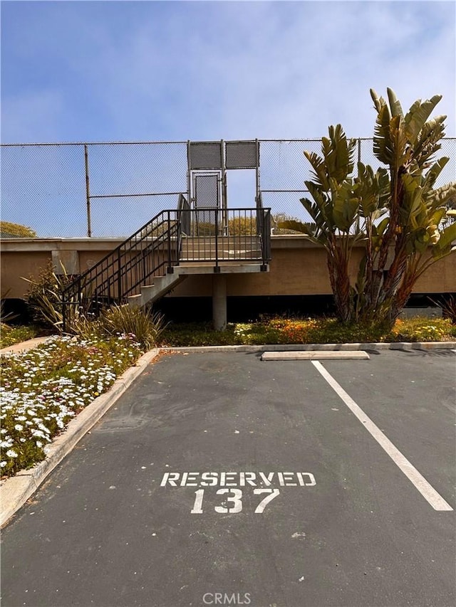 17114 Bluewater Ln Unit 141, Huntington Beach, CA 92649 - view of front of home with uncovered parking and fence