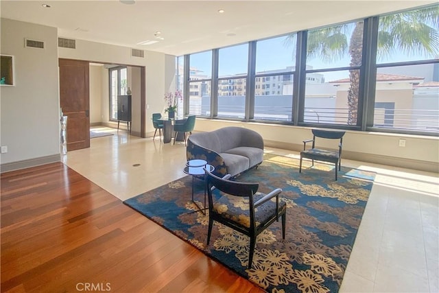 interior space with visible vents, baseboards, and wood finished floors
