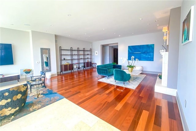 living room with recessed lighting, baseboards, and wood finished floors