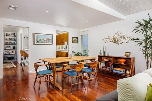 dining area featuring wood finished floors and visible vents