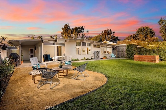 back of house featuring a yard, fence, a patio, and stucco siding