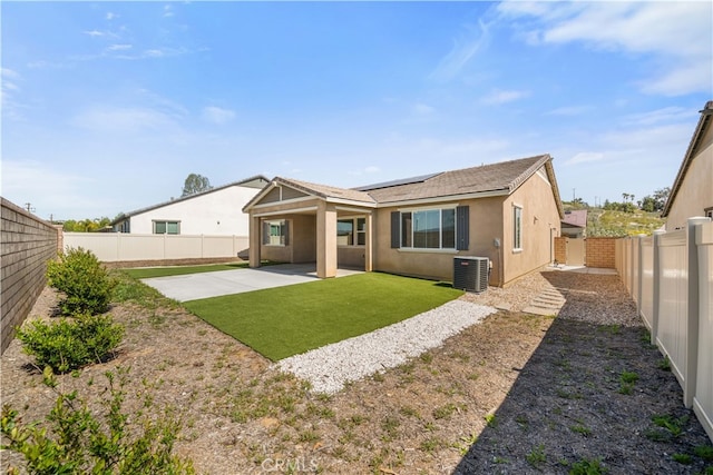 29391 Santa Ynez Cir, Menifee, CA 92584 - back of property featuring a patio, stucco siding, central AC unit, a fenced backyard, and solar panels
