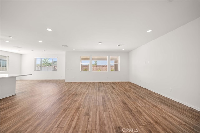 29391 Santa Ynez Cir, Menifee, CA 92584 - unfurnished living room featuring light wood finished floors, baseboards, and recessed lighting