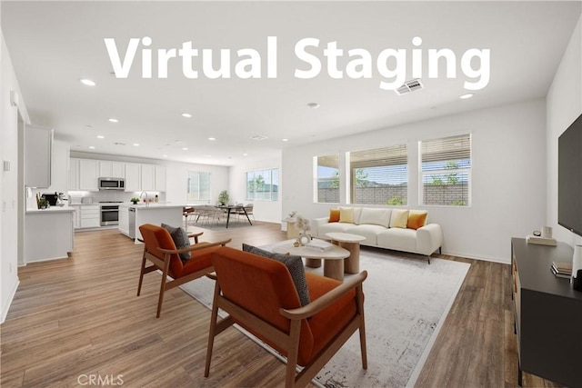 29391 Santa Ynez Cir, Menifee, CA 92584 - living area with visible vents, light wood-style flooring, and recessed lighting