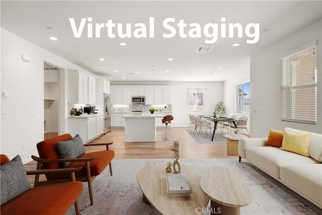 29391 Santa Ynez Cir, Menifee, CA 92584 - living room featuring visible vents, light wood-type flooring, and recessed lighting