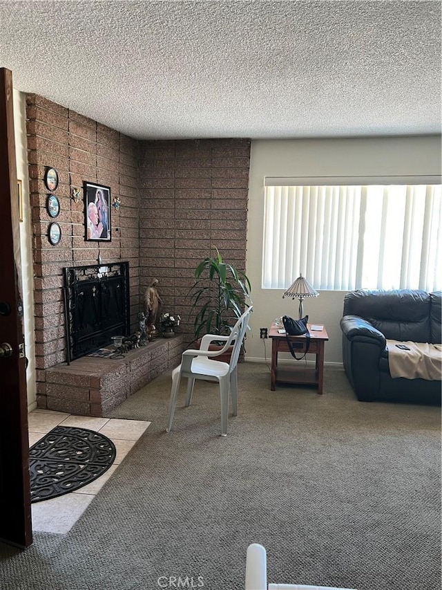 carpeted living area featuring a fireplace and a textured ceiling