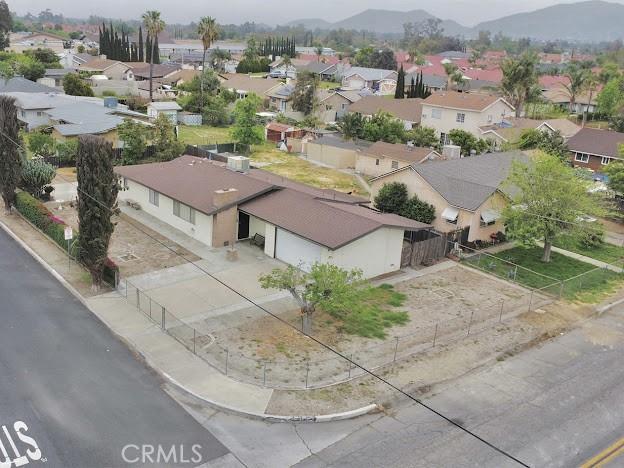 birds eye view of property with a mountain view and a residential view