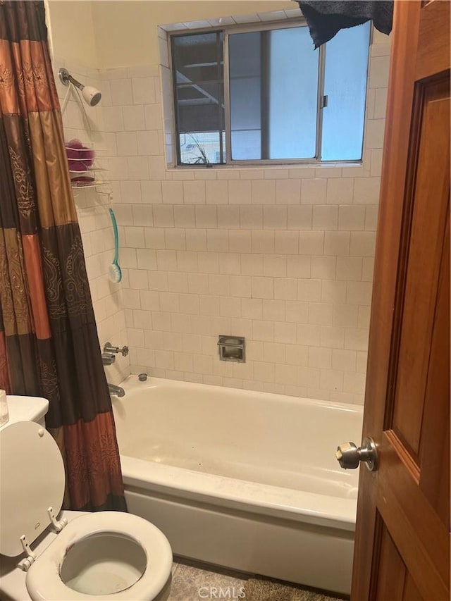 bathroom featuring toilet and shower / bath combo with shower curtain