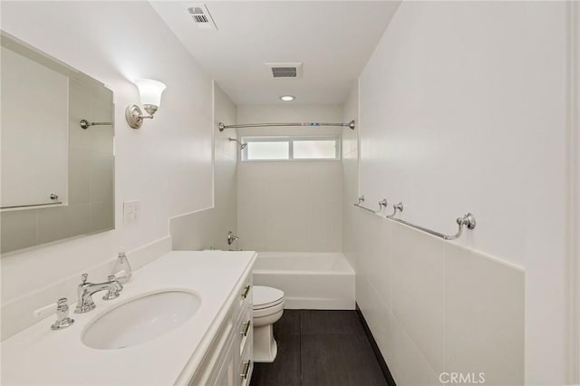 full bathroom featuring bathing tub / shower combination, visible vents, vanity, and toilet
