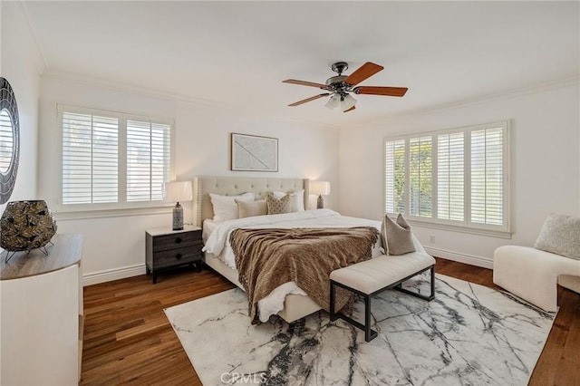 bedroom with ceiling fan, wood finished floors, baseboards, and ornamental molding
