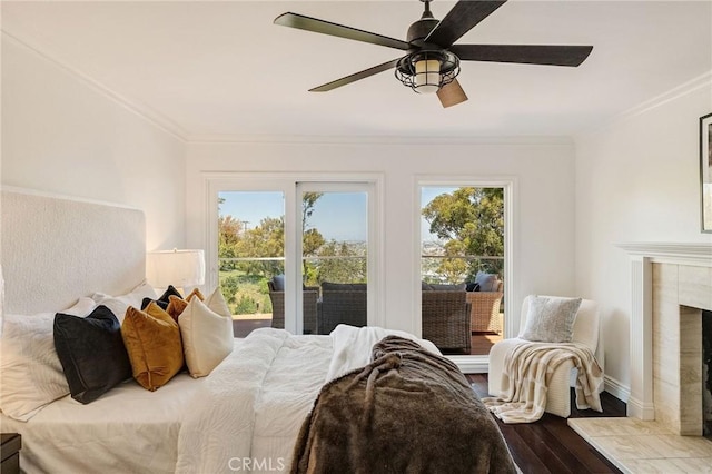 bedroom featuring wood finished floors, ornamental molding, and multiple windows