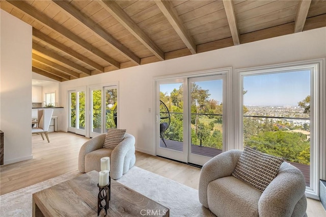 sunroom / solarium with beamed ceiling, french doors, and a healthy amount of sunlight