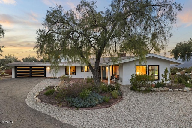 1417 Foothill Rd, Ojai, CA 93023 - mid-century home featuring driveway, an attached garage, and stucco siding