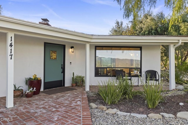1417 Foothill Rd, Ojai, CA 93023 - doorway to property featuring stucco siding and a chimney