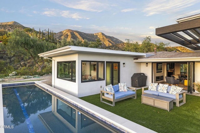 1417 Foothill Rd, Ojai, CA 93023 - rear view of property with a mountain view, outdoor lounge area, an outdoor pool, stucco siding, and a yard