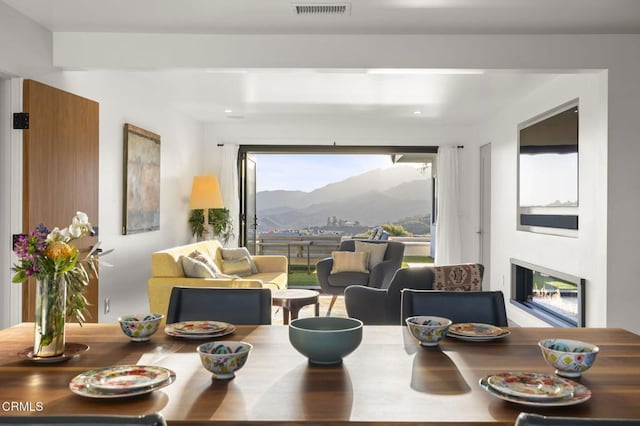1417 Foothill Rd, Ojai, CA 93023 - dining space with a mountain view, a glass covered fireplace, and plenty of natural light