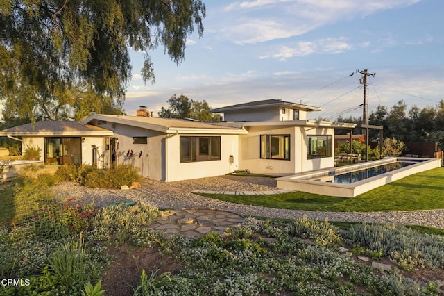 1417 Foothill Rd, Ojai, CA 93023 - back of property featuring stucco siding, a chimney, a yard, and an outdoor pool