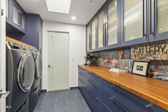 1417 Foothill Rd, Ojai, CA 93023 - washroom with washing machine and dryer, dark tile patterned flooring, cabinet space, recessed lighting, and baseboards