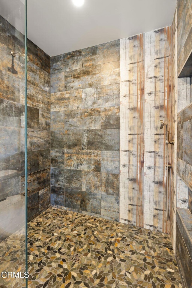1417 Foothill Rd, Ojai, CA 93023 - bathroom featuring a tile shower and stone finish flooring