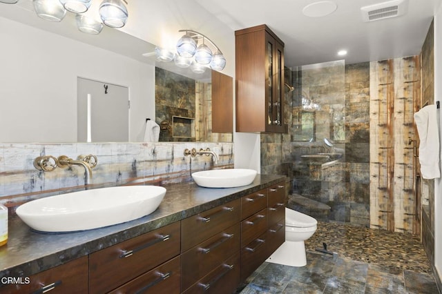 1417 Foothill Rd, Ojai, CA 93023 - full bath featuring double vanity, toilet, a tile shower, and tasteful backsplash