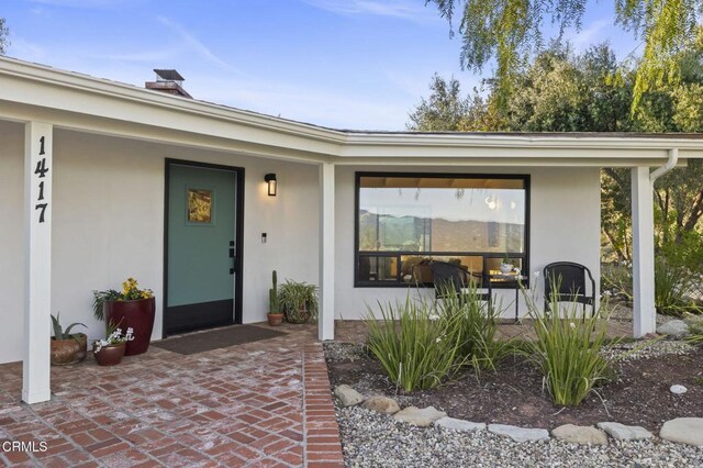 1417 Foothill Rd, Ojai, CA 93023 - property entrance featuring stucco siding and a chimney