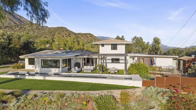 1417 Foothill Rd, Ojai, CA 93023 - back of property featuring a mountain view, a lawn, outdoor lounge area, a pergola, and stucco siding