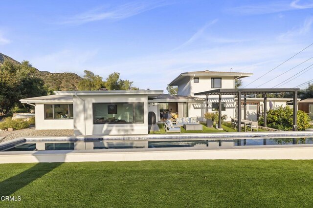 1417 Foothill Rd, Ojai, CA 93023 - rear view of property featuring a lawn, an outdoor pool, a patio area, and stucco siding