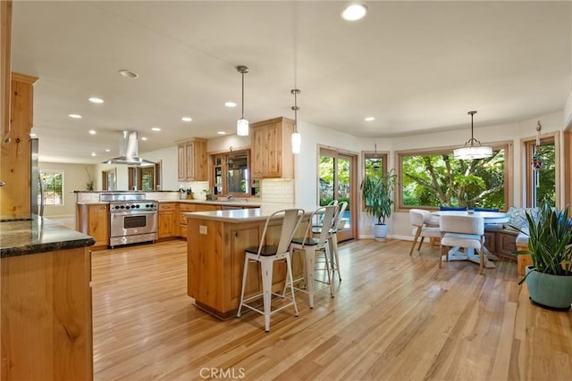 15 Quadra Ct, Chico, CA 95928 - kitchen with appliances with stainless steel finishes, island range hood, a peninsula, recessed lighting, and light wood-type flooring
