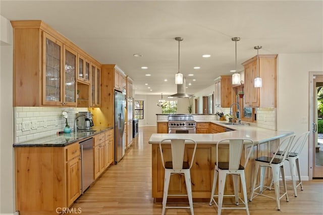 15 Quadra Ct, Chico, CA 95928 - kitchen featuring a peninsula, appliances with stainless steel finishes, light wood-type flooring, ventilation hood, and recessed lighting