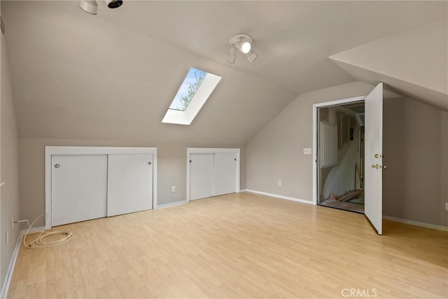 15 Quadra Ct, Chico, CA 95928 - bonus room featuring a skylight, vaulted ceiling, light wood-type flooring, and baseboards