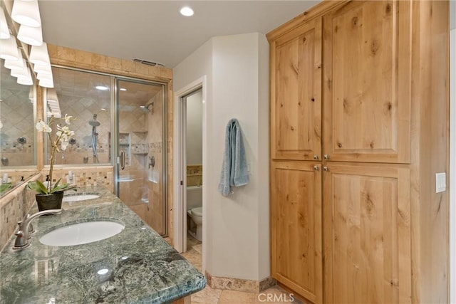 15 Quadra Ct, Chico, CA 95928 - bathroom featuring toilet, double vanity, a shower stall, tile patterned flooring, and recessed lighting