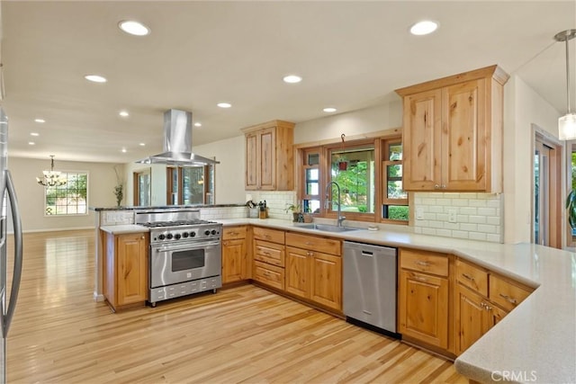 15 Quadra Ct, Chico, CA 95928 - kitchen with stainless steel appliances, island range hood, a sink, a peninsula, and light wood-style floors
