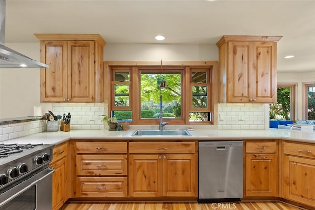 15 Quadra Ct, Chico, CA 95928 - kitchen with appliances with stainless steel finishes, wall chimney exhaust hood, a sink, light countertops, and decorative backsplash