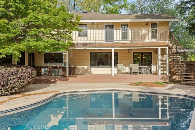 15 Quadra Ct, Chico, CA 95928 - rear view of property with stairway, a wooden deck, an outdoor pool, a balcony, and a patio