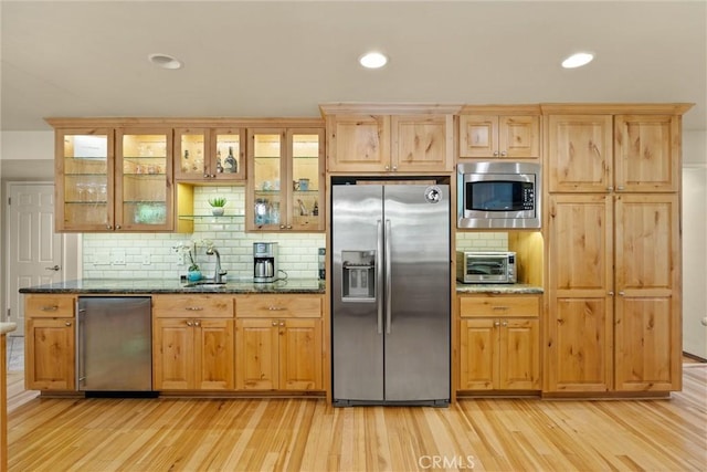 15 Quadra Ct, Chico, CA 95928 - kitchen with appliances with stainless steel finishes, light wood-style flooring, decorative backsplash, dark stone countertops, and recessed lighting
