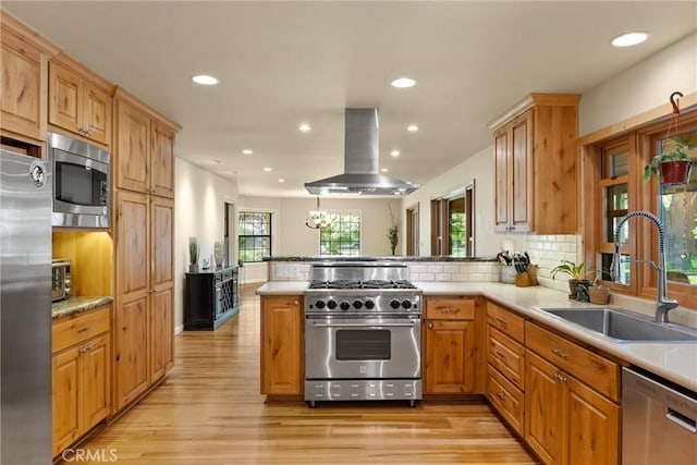 15 Quadra Ct, Chico, CA 95928 - kitchen featuring appliances with stainless steel finishes, island exhaust hood, a peninsula, recessed lighting, and light wood finished floors
