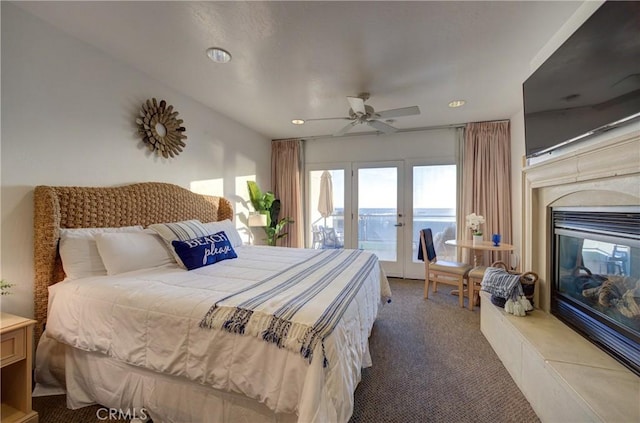bedroom with access to outside, recessed lighting, carpet floors, french doors, and a high end fireplace