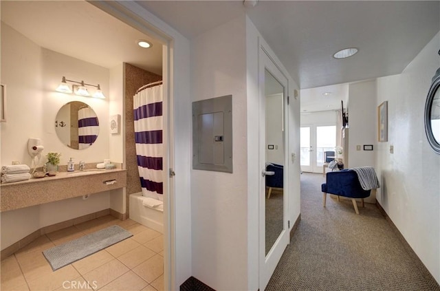 ensuite bathroom with ensuite bathroom, baseboards, electric panel, recessed lighting, and vanity