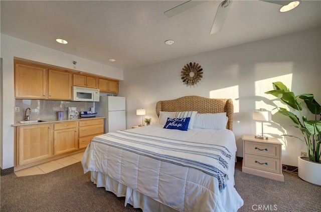 bedroom with a sink, ceiling fan, freestanding refrigerator, recessed lighting, and light colored carpet
