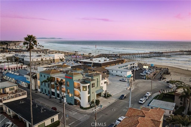 birds eye view of property with a water view and a view of the beach
