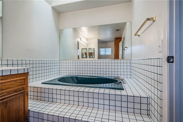 bathroom featuring visible vents and a garden tub