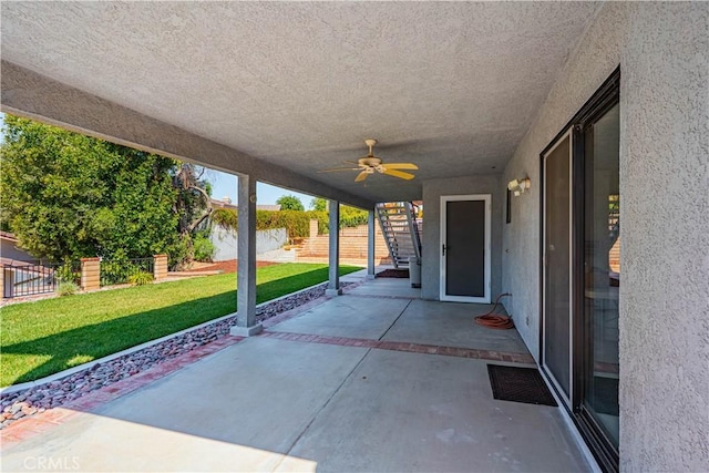 view of patio with a fenced backyard and a ceiling fan