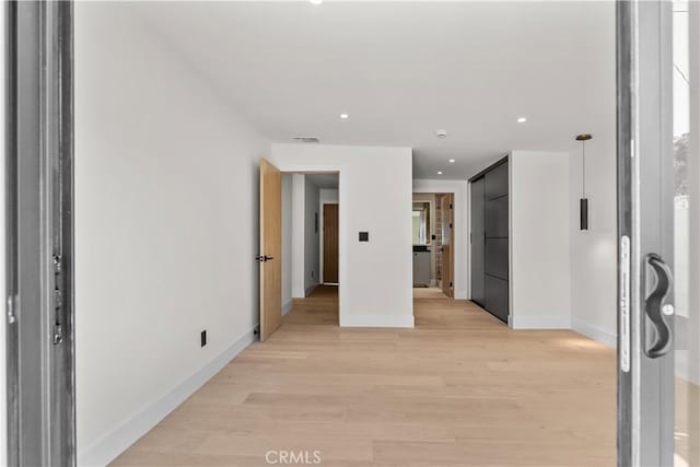 hall with recessed lighting, visible vents, light wood-type flooring, and baseboards