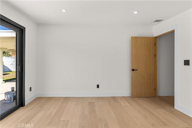 spare room with recessed lighting, light wood finished floors, and baseboards