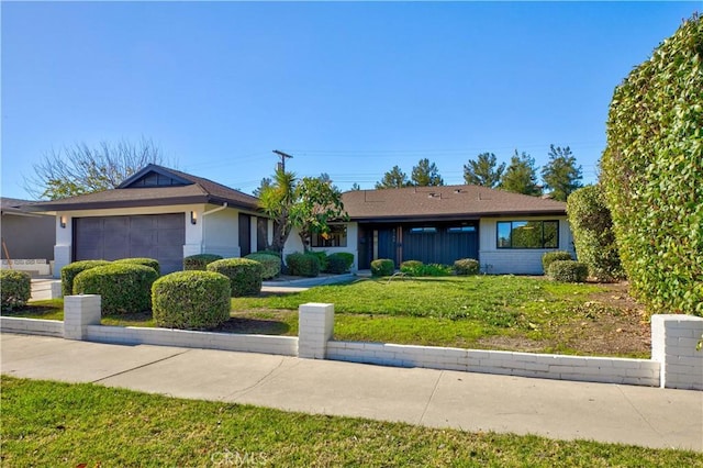 single story home with a front yard and an attached garage